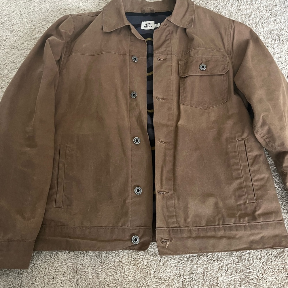 Men's Flint & Tinder flannel lined waxed trucker jacket.